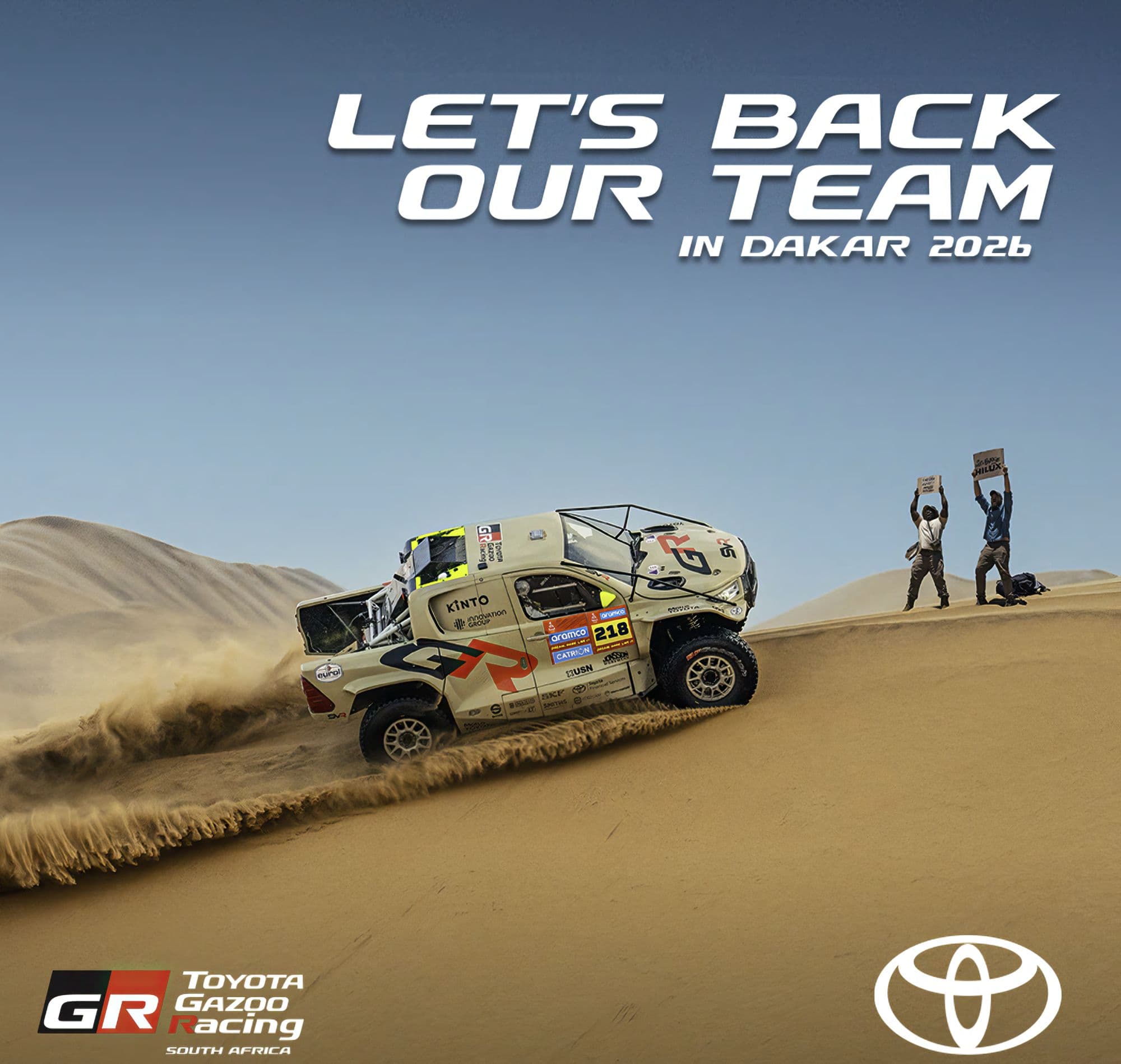 Toyota Gazoo Racing rally car kicks up sand on desert dunes with cheering fans nearby.